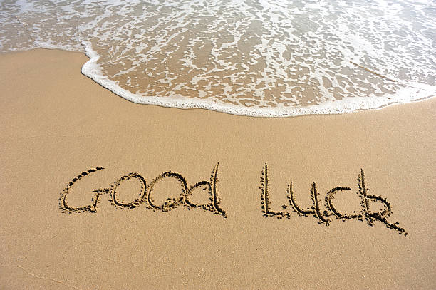 istock word good luck drawn on the beach 460358435
