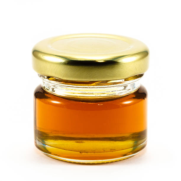 istock Honey in the bottle glass 460387667