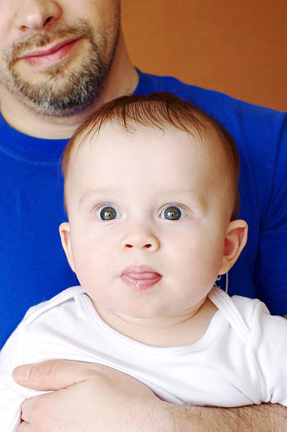 istock six-months baby on father hands 460388813