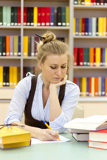 istock Portrait of clever student with open book reading 460390119