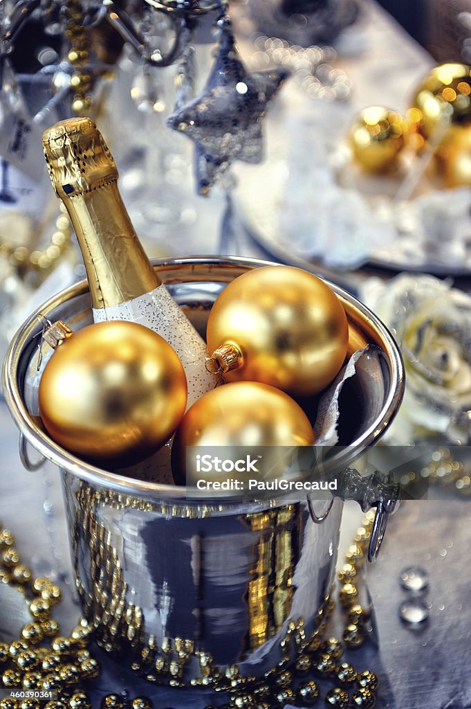 Christmas table setting with champagne Christmas table setting with champagne in gold and silver tone New Year's Eve Stock Photo