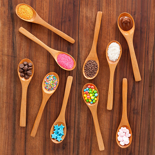 istock Scattered spoons with dessert toppings 460391359