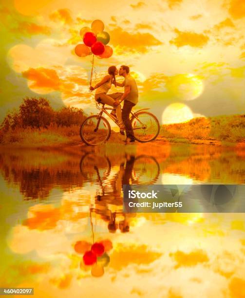 Silhouette Of Two People Young Couple Sitting One Bicycle Stock Photo - Download Image Now