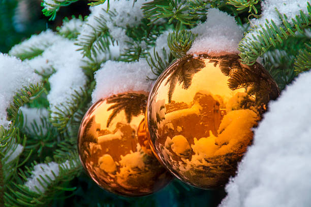Snow Covered Christmas Tree Ornaments Reflect Santa Fe Adobe Buildings stock photo