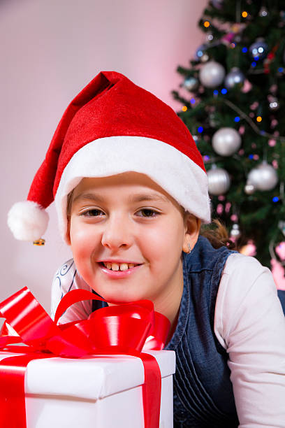 istock Little girl holding Christmas present 460413863