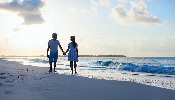 istock Couple on beach at sunset 460421699