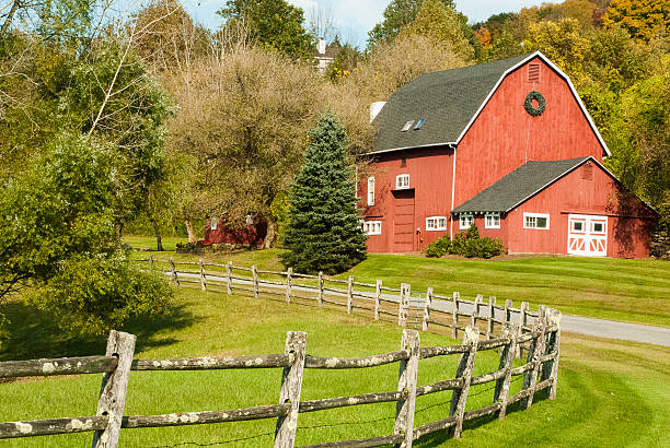 Classic New England Red Barn near Kent Connecticut A classic New England red barn near Kent Connecticut along with a nice wooden split-rail fence in the early fall. rail fence stock pictures, royalty-free photos & images