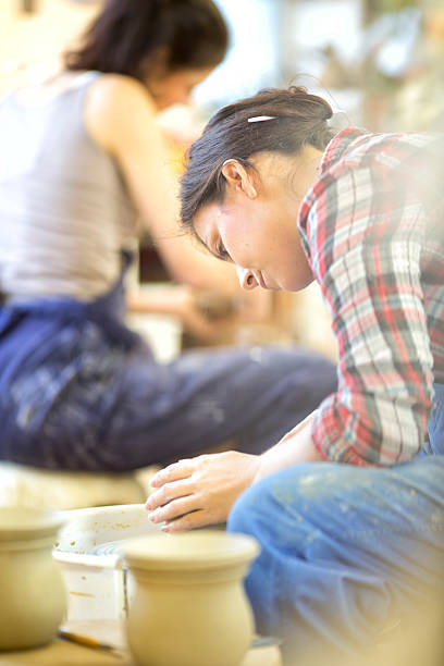 istock Potter working clay on potter's wheel 460422289