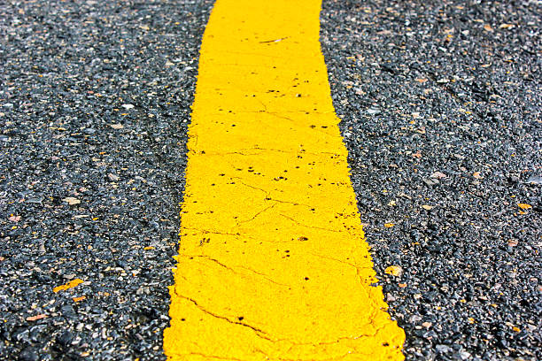istock asphalt road yellow line close up background 460423461