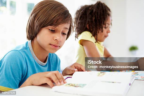 Children Doing Homework In Kitchen Together Stock Photo - Download Image Now - 8-9 Years, Boys, Homework