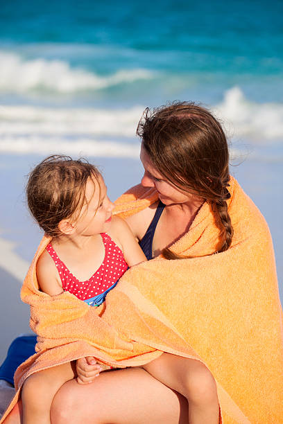 istock Mother and daughter at beach 460429595