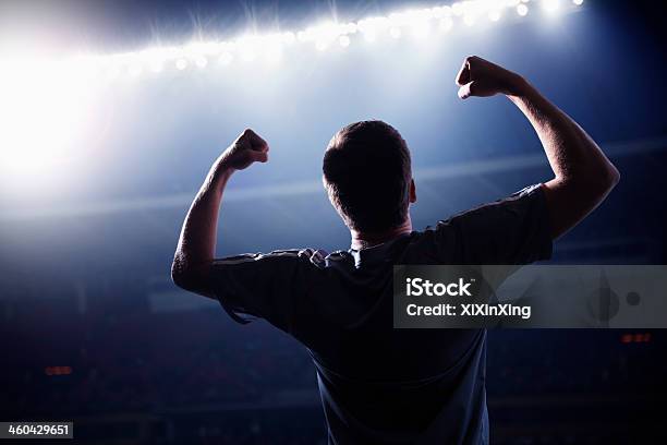 Soccer Player Cheering With His Arms Raised In The Stadium Stock Photo - Download Image Now