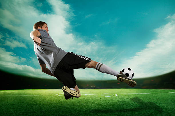 istock Soccer player kicking the ball in mid air 460429659
