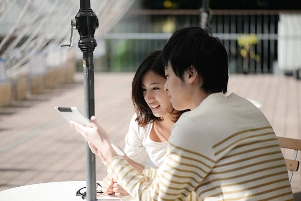 Young couple Two people to discuss how to use the tablet only japanese stock pictures, royalty-free photos & images
