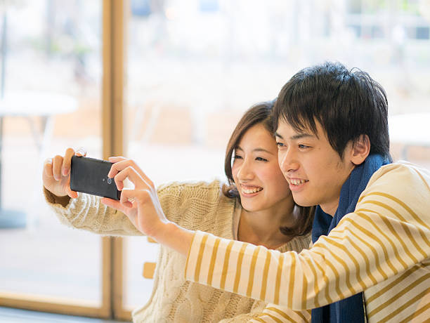 Smiling young couple taking selfie with a smartphone