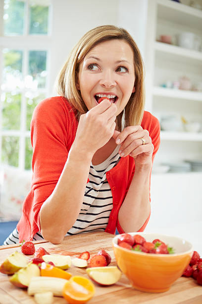 kobieta przygotowanie sałatka owocowa w kuchni - fruit salad fruit healthy eating making zdjęcia i obrazy z banku zdjęć