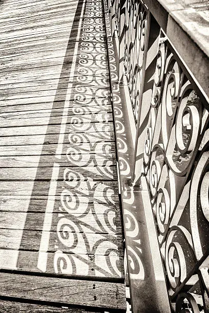 vintage style detail of an old bridge with decorated handrail.