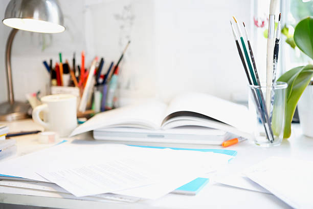 istock Desk With Books; Papers And Brushes 460450073