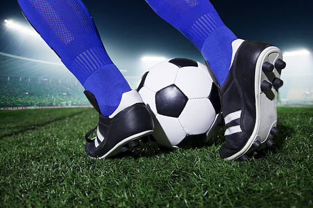 istock Feet kicking the soccer ball 460450149