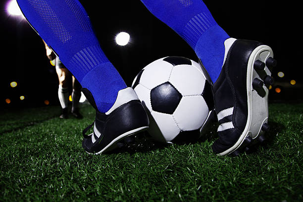 istock Feet kicking the soccer ball 460450151