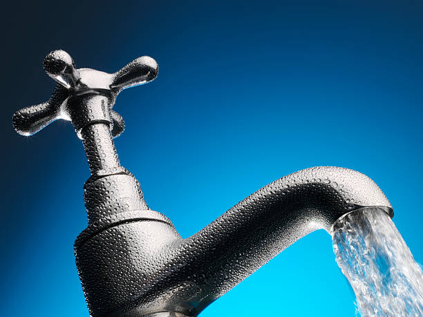istock Water pouring from tap close-up 460450171