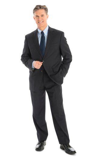 Full length portrait of confident mature businessman in formals standing isolated over white background