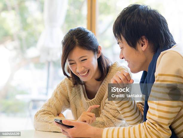 Young Couple Watching Any Contents On A Smartphone Stock Photo - Download Image Now - Japanese Ethnicity, Smart Phone, Japan