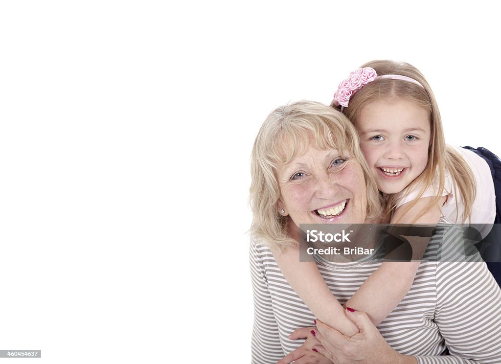 Grandmother & Granddaughter Smiling A happy and smiling grandmother & granddaughter isolated against a plain white background. Active Seniors Stock Photo