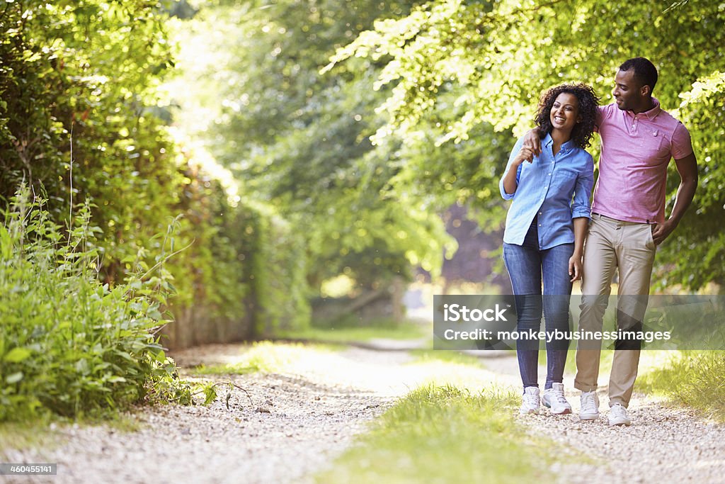 A couple walking in the countryside Young African American Couple Walking In Countryside On Sunny Day African-American Ethnicity Stock Photo