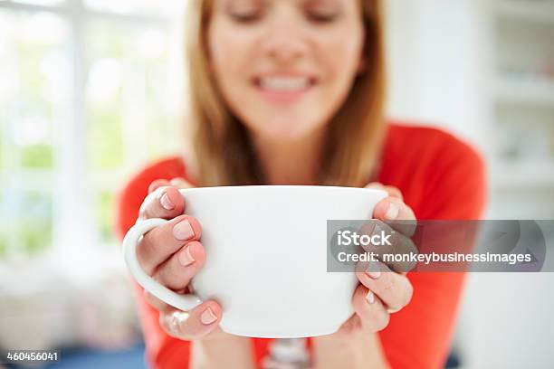 Woman Relaxing At Home With Hot Drink Stock Photo - Download Image Now - 40-49 Years, Adult, Adults Only