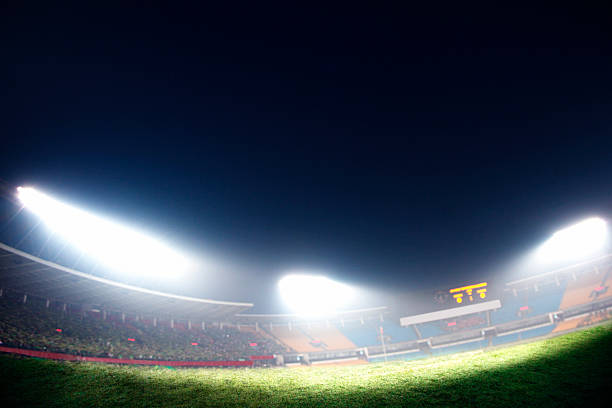 istock Digital composite of soccer field and night sky 460456313