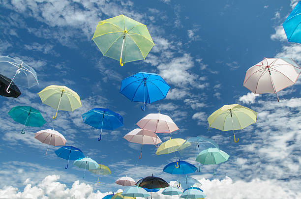 istock Multicolored umbrellas against blue sky background 460462093