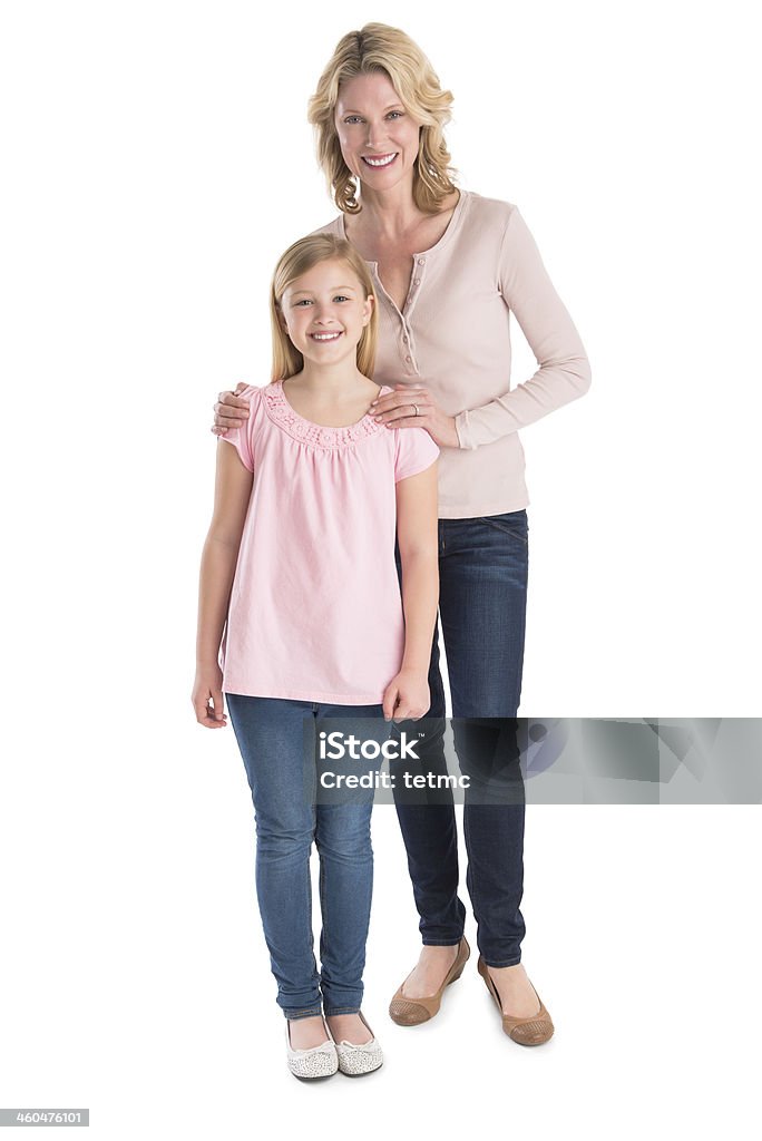 Mother And Daughter Smiling Together Over White Background Full length portrait of mother and daughter smiling together over white background Mother Stock Photo