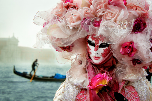 portrait of a cute preschool girl in Venice wearing Carnaval mask.