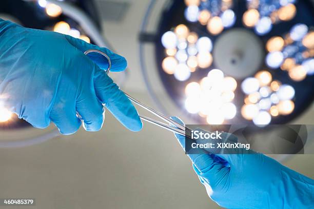 Closeup Of Gloved Hands Passing The Surgical Scissors Stock Photo - Download Image Now