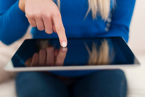 istock Close up of woman using digital tablet 460487793