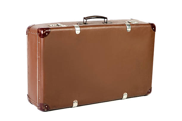 old suitcase at an angle before white background stock photo