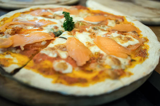 istock Smoked salmon pizza produces from wood fired oven. 460490641