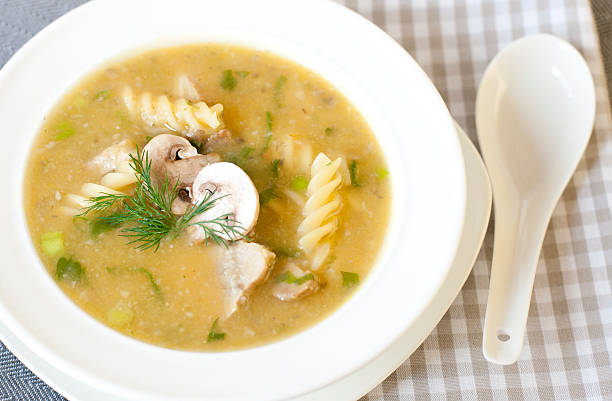 Pumpkin-mushroom soup in a white plate stock photo