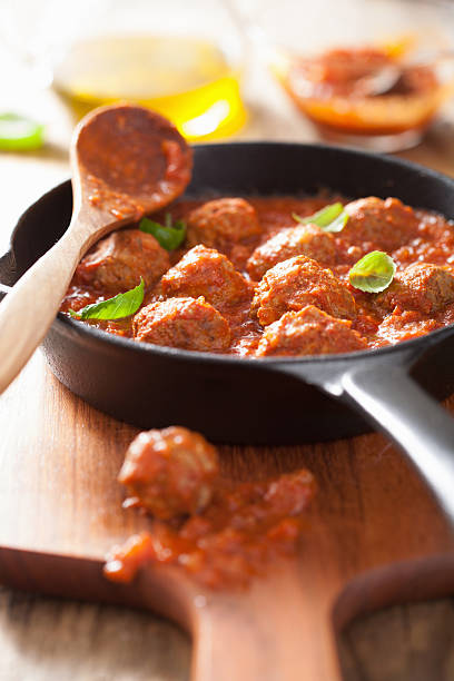 istock meatballs with tomato sauce in black pan 460492307