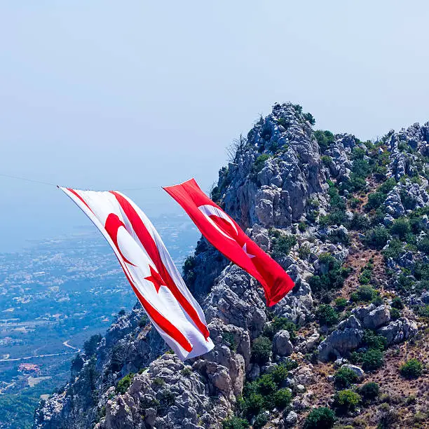 Enormous Turkey and North Cyprus flags between mountains near Saint Hilarion castle, Kyrenia mountain range, North Cyprus