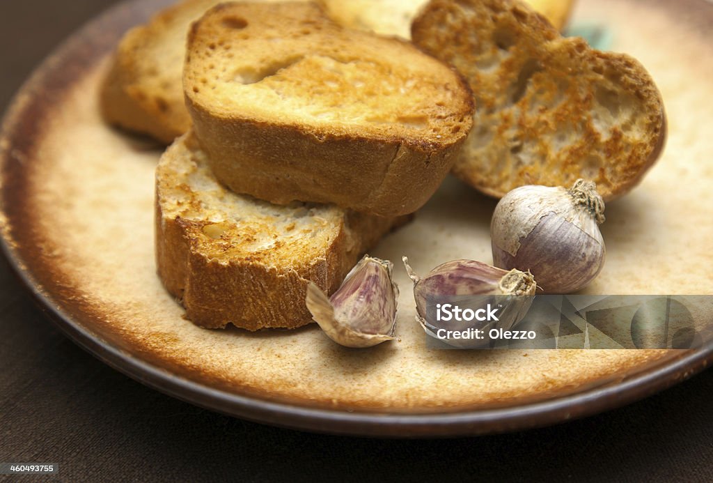 slice of grilled baguette and garlic slice of grilled baguette and garlic on brown napkin Appetizer Stock Photo