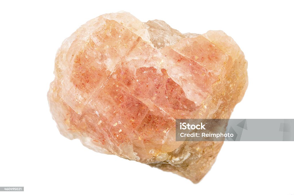 Uncut and raw orange Sunstone Sunstone is an interesting feldspar gemstone with a glittery appearance. This one is brightly orange, rough, raw and uncut. Feldspar Stock Photo