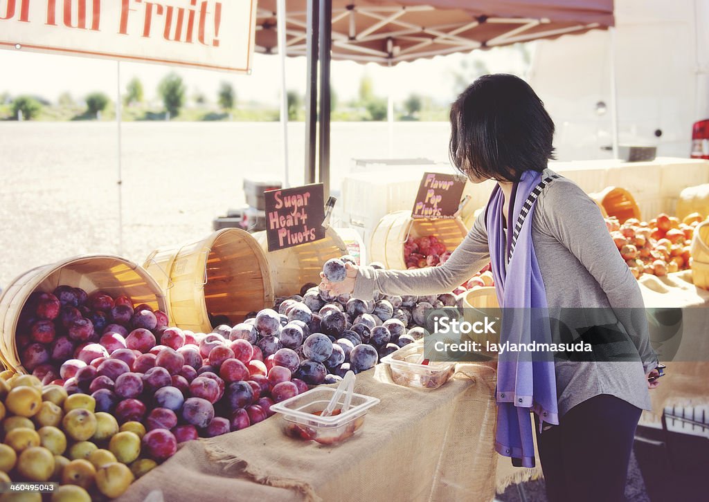 Woman Shopping Outdoors - Fruit Woman shopping for fruit at an outdoor market Adult Stock Photo