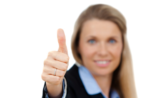 Portrait of a confident young business woman giving you a thumbs up sign isolated against white.