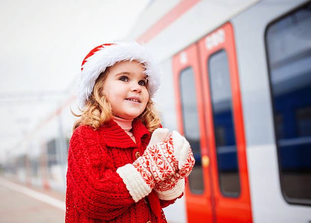 istock Little girl Santa waiting for a train 460495883