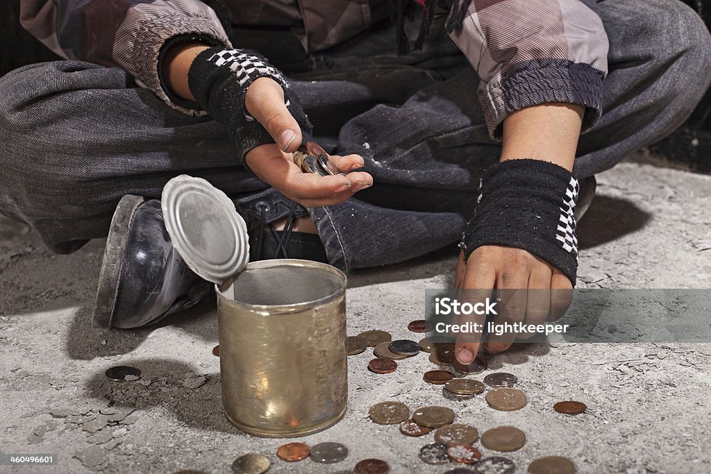 Beggar child counting coins sitting on damaged concrete floor Beggar child counting coins sitting on damaged concrete floor - closeup on hands Beggar Stock Photo