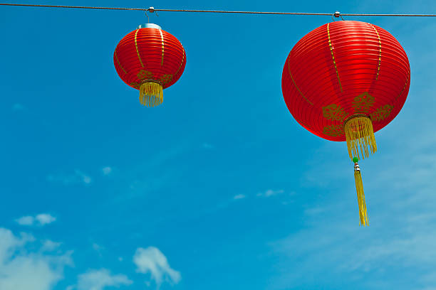 istock Red Chinese Paper Lanterns against a Blue Sky 460499421