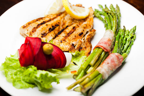 istock Blackened fish and asparagus wrapped in bacon 460500123