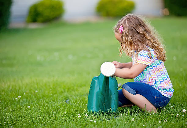 istock Girl With Watering Can 460500703